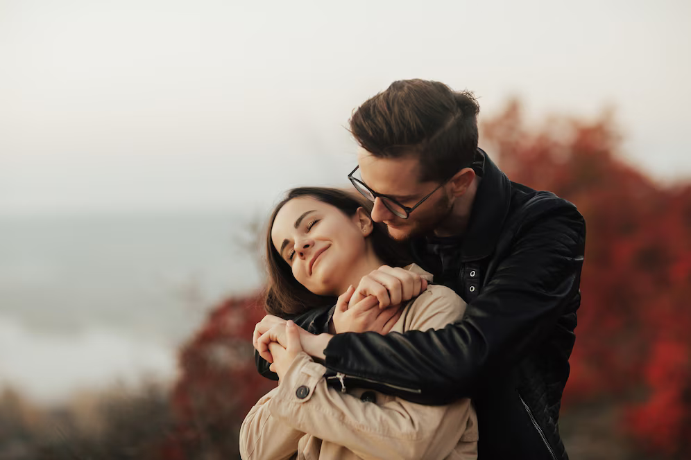 amazing-close-up-portrait-cheerful-woman-laughing-with-closed-eyes-while-man-embracing-her-from-back